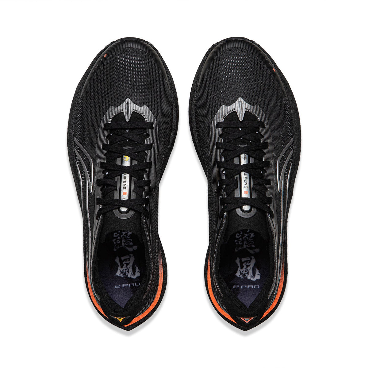 Pair of black running shoes, top view with laces, silver stripes, orange-lined collar