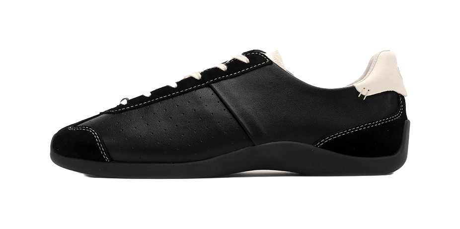 Black low-top trainers with lace-up front and perforated side panels, antique white detail