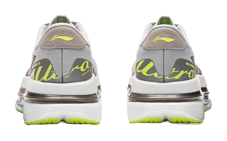 Women's low-top running shoes, heel view, calm gray with neon green logo and sole