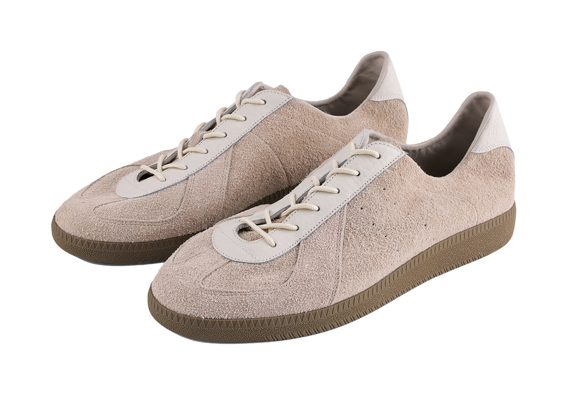 Khaki suede low-top sneakers with two white lace patches and cream laces
