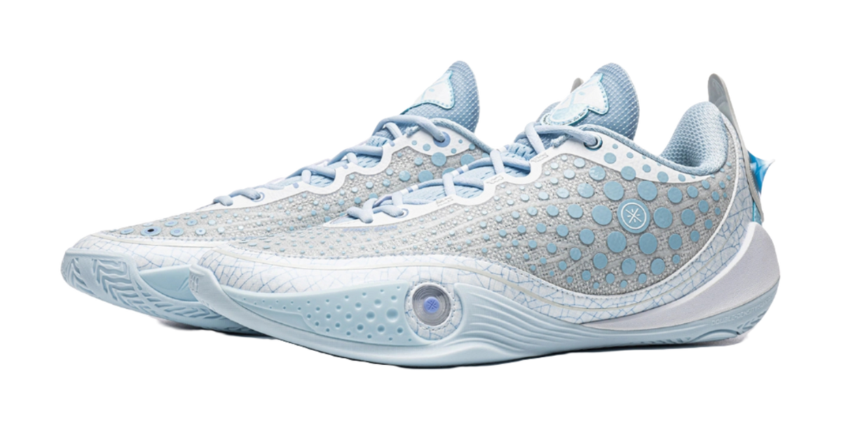 Ice blue low basketball shoe with lace-up front and decorative logo on side