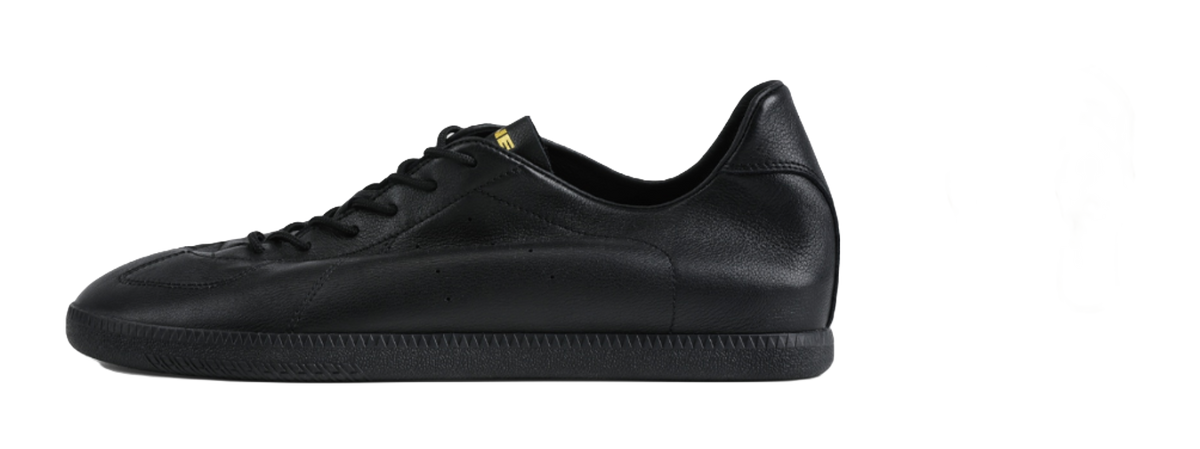 Black low-top training sneaker, side view, black laces and leather upper