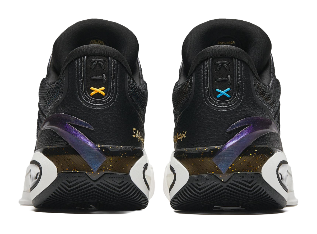 Heel and side view of black and white basketball shoes with colorful logo accents