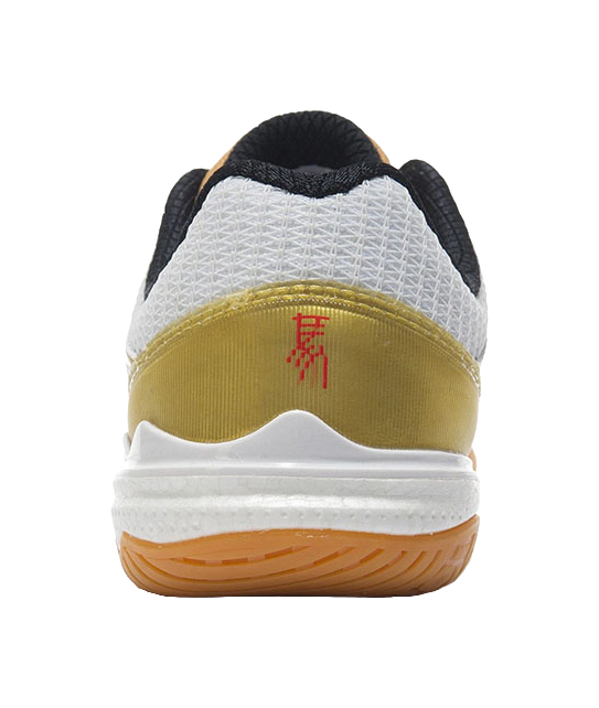 White table tennis shoe heel with black collar lining and gold panel, outsole close-up.
