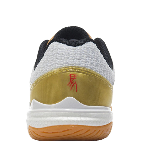 White table tennis shoe heel with black collar lining and gold panel, outsole close-up.