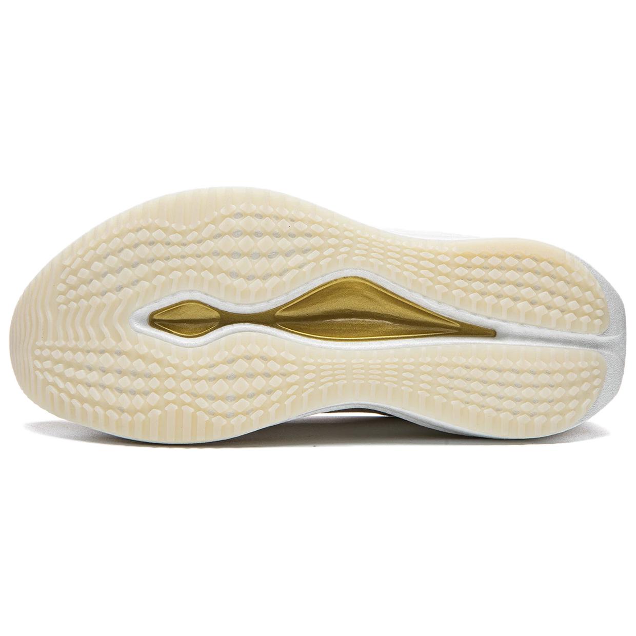Undersole of khaki running shoe with gold side stripe and textured tread