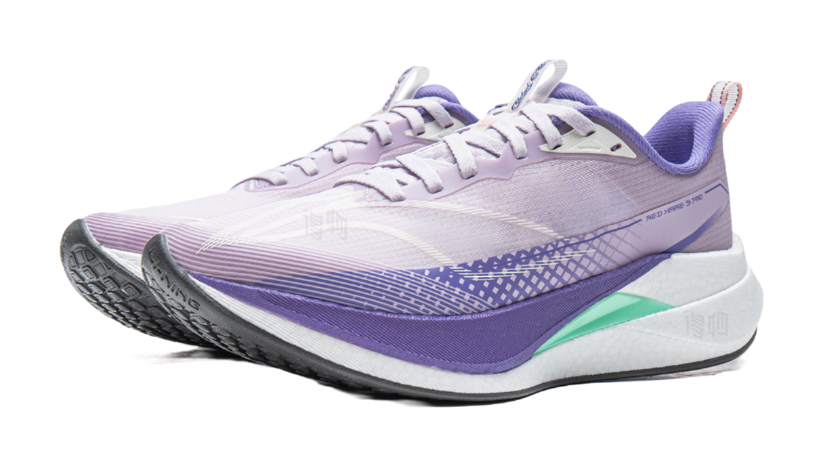 Lavender purple running shoe with white laces, purple trim, and green heel accent