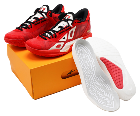 Red low-top basketball shoes with black laces, white logo, and gray insole