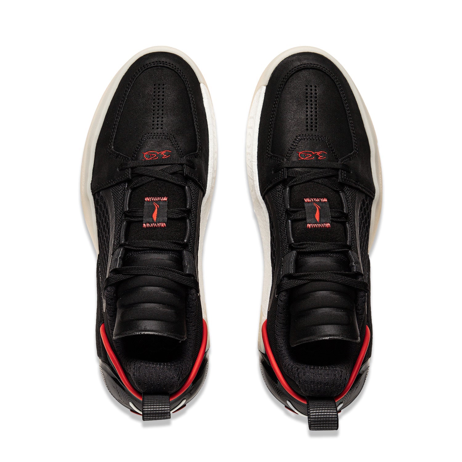 Pair of black basketball shoes with red trim and white soles, lace-up.