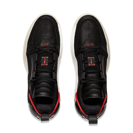 Pair of black basketball shoes with red trim and white soles, lace-up.