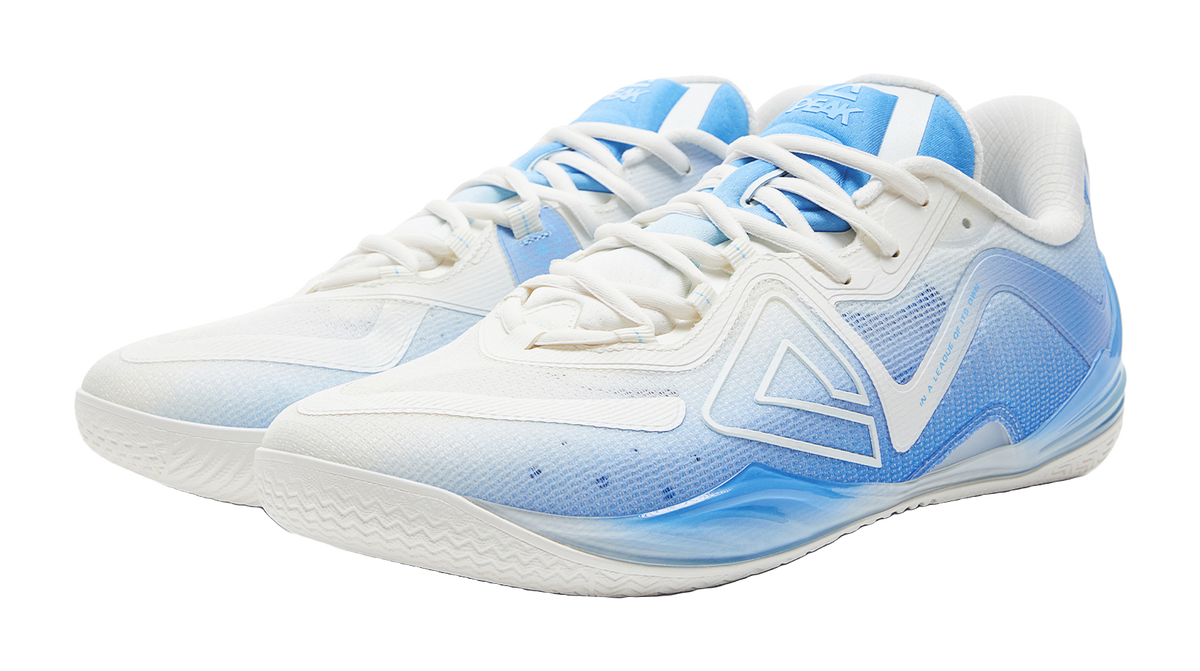 White and blue basketball shoe, three-quarter view with blue patterned toe and laces