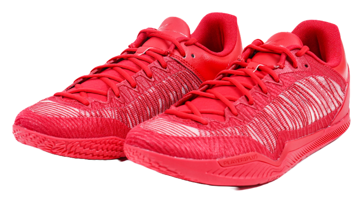 Pair of red basketball shoes with lace-up fronts and textured knit uppers