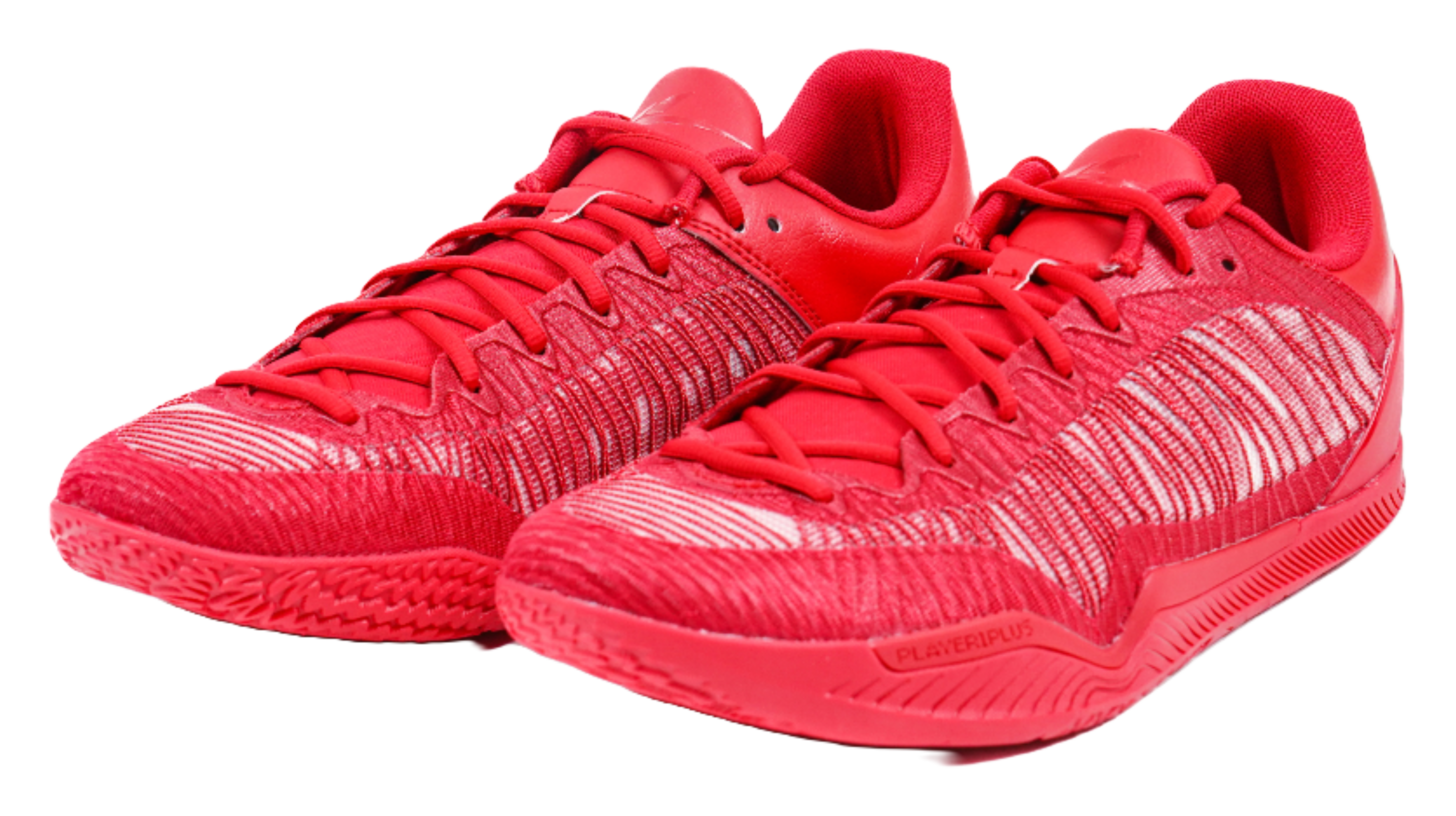 Pair of red basketball shoes with lace-up fronts and textured knit uppers