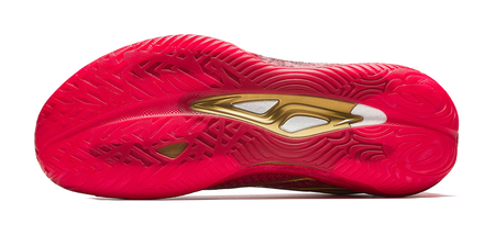 Red shoe outsole with textured traction pattern and gold branding on heel.