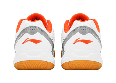 Pair of white-and-orange badminton shoes with gray heel panels and orange trim