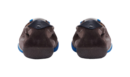 Low-top sneakers heel view, brown fabric uppers with blue trim along the edges