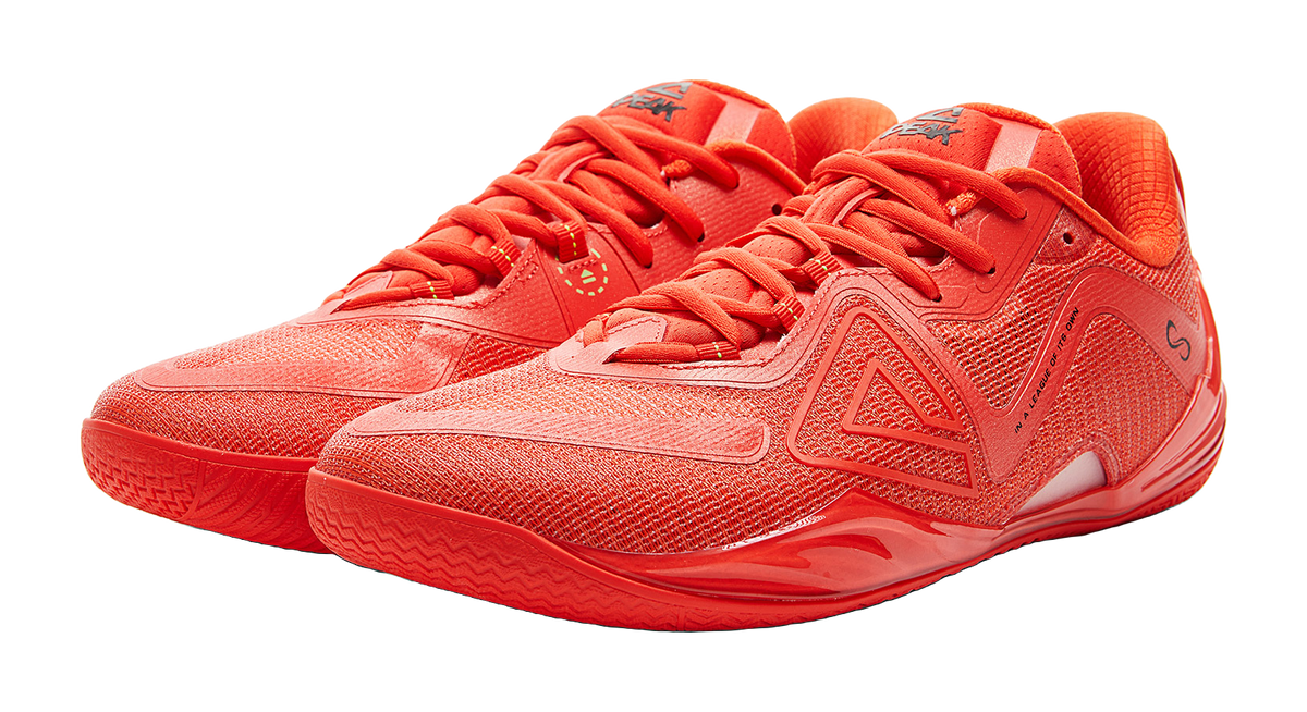 Orange-red lace-up basketball shoes pair, three-quarter view with mesh-textured panels.