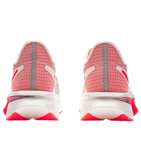 Running shoe heel view with white collar lining, red mesh panels, and black stripe