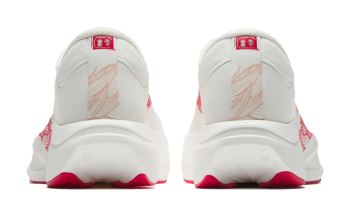 White running shoe heels with red trim and rear logo badge