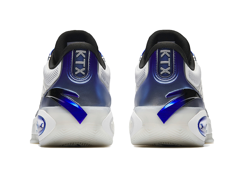 Back view of silver low basketball shoes with blue heel panel and rear logo