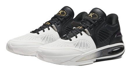 Pair of black and white basketball shoes with padded collars and lace-up fronts