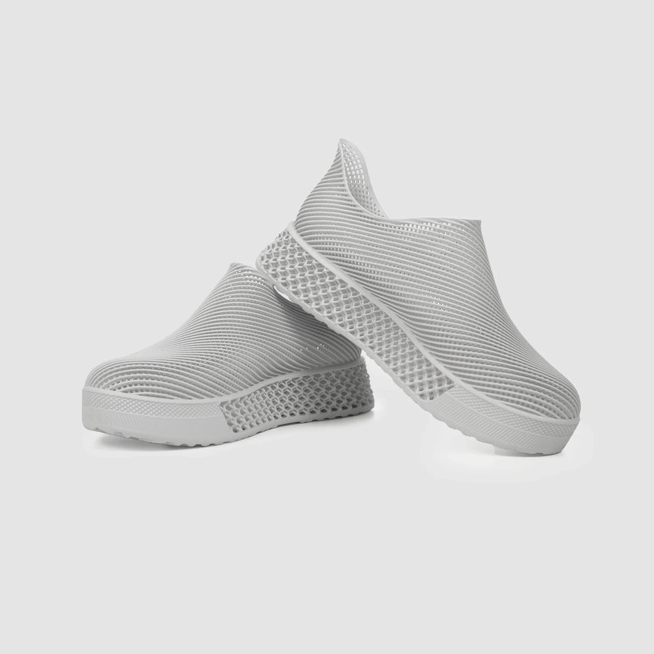 Gray 3D printed sneakers with mesh-like knit upper and ridged textured sole
