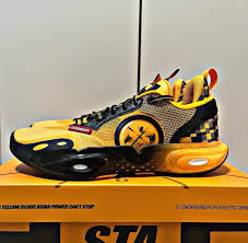 Li-Ning basketball shoe, yellow upper with black and orange details and thick translucent sole