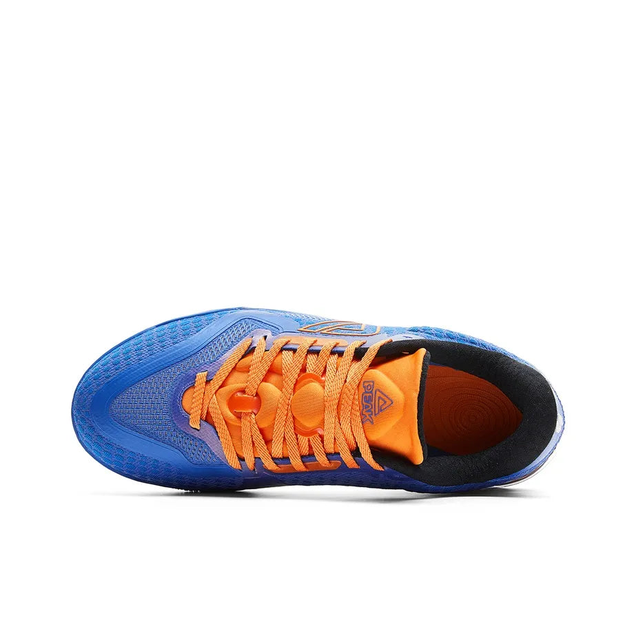 Blue basketball shoe with orange laces and black inner lining, side panel detail