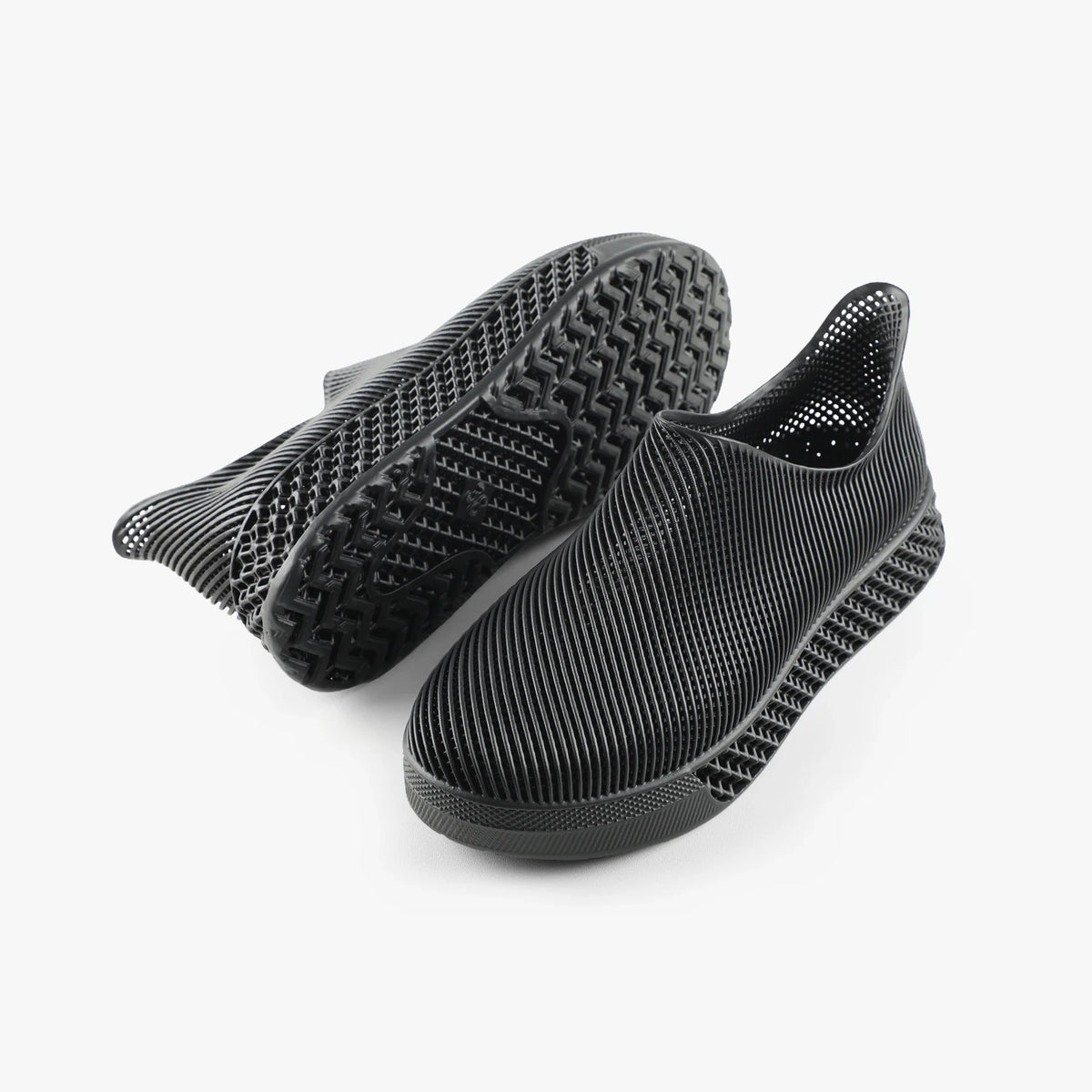 3D printed slip-on sneakers, dark black with treaded outsole visible