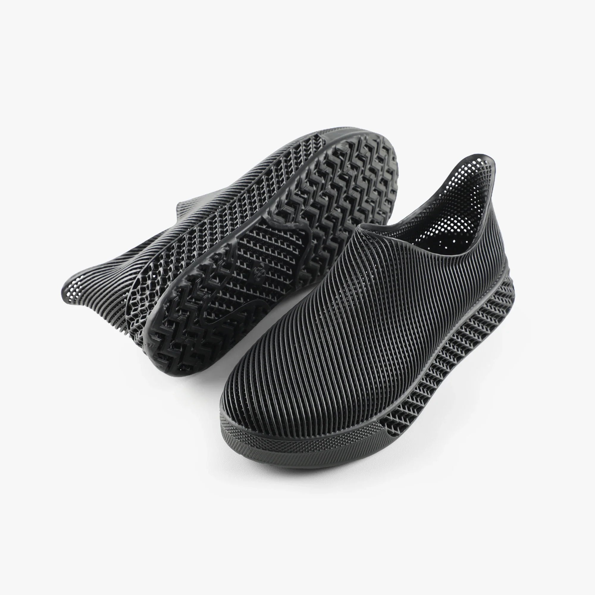 3D printed slip-on sneakers, dark black with treaded outsole visible