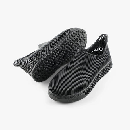 3D printed slip-on sneakers, dark black with treaded outsole visible