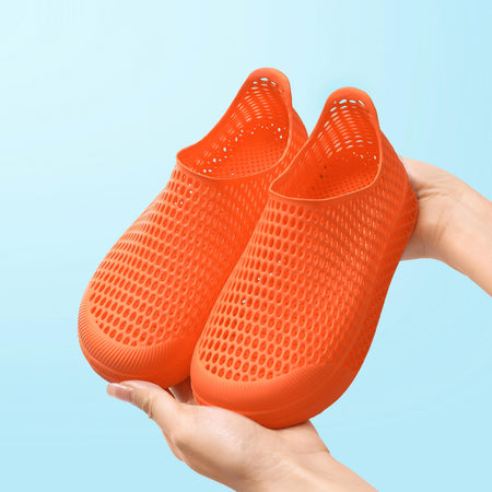 Orange 3D-printed kids slip-on shoes with perforated knit texture