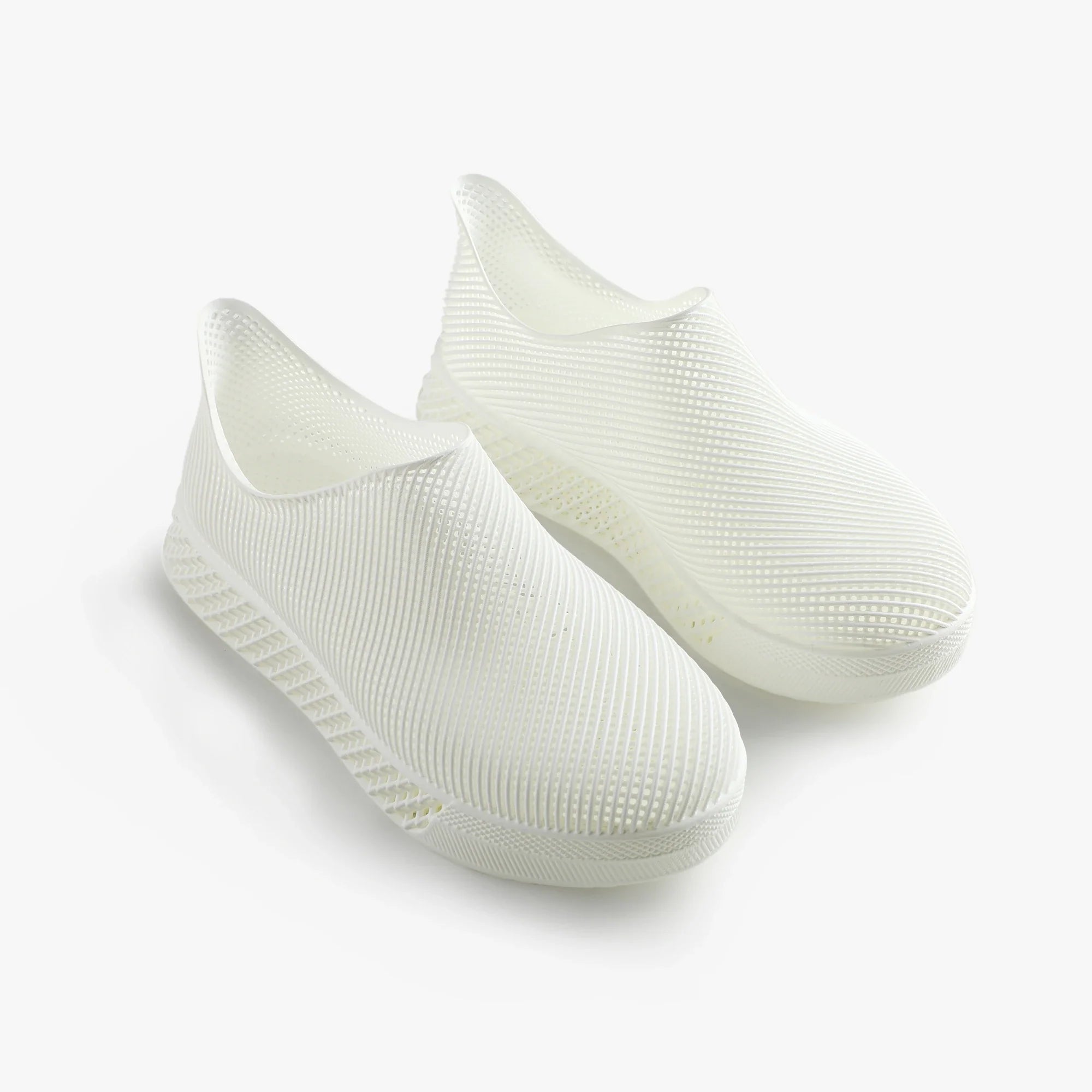3D printed slip-on sneakers, light white pair with ribbed textured upper