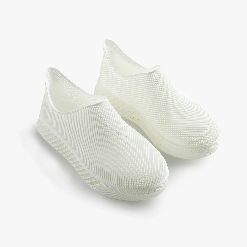 White 3D printed slip-on sneakers with ribbed upper and raised outsole