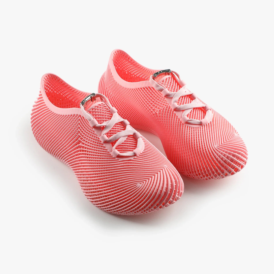 Pink 3D-printed sneakers with lace-up front and mesh-like lattice upper