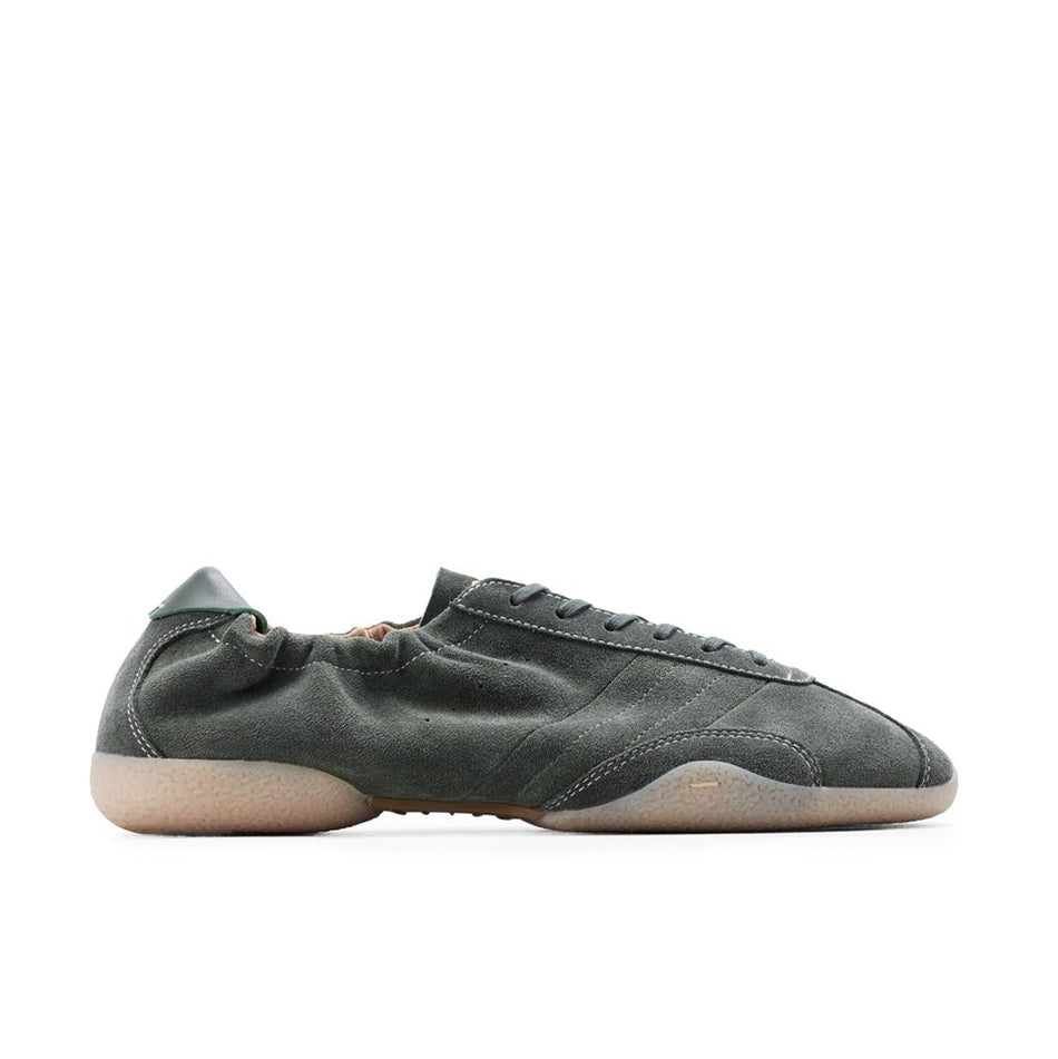 A single dark olive green leather sneaker with a beige sole, shown in profile against a white background, captured within a mobile phone screenshot interface.