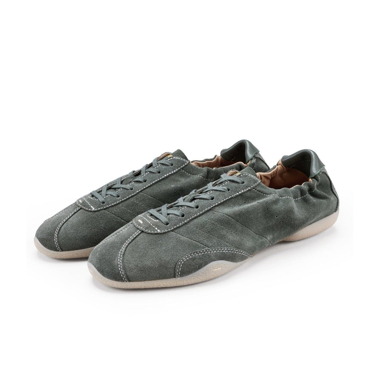 A pair of low-top suede sneakers in a muted gray-green color with white soles, shown on a plain white background.