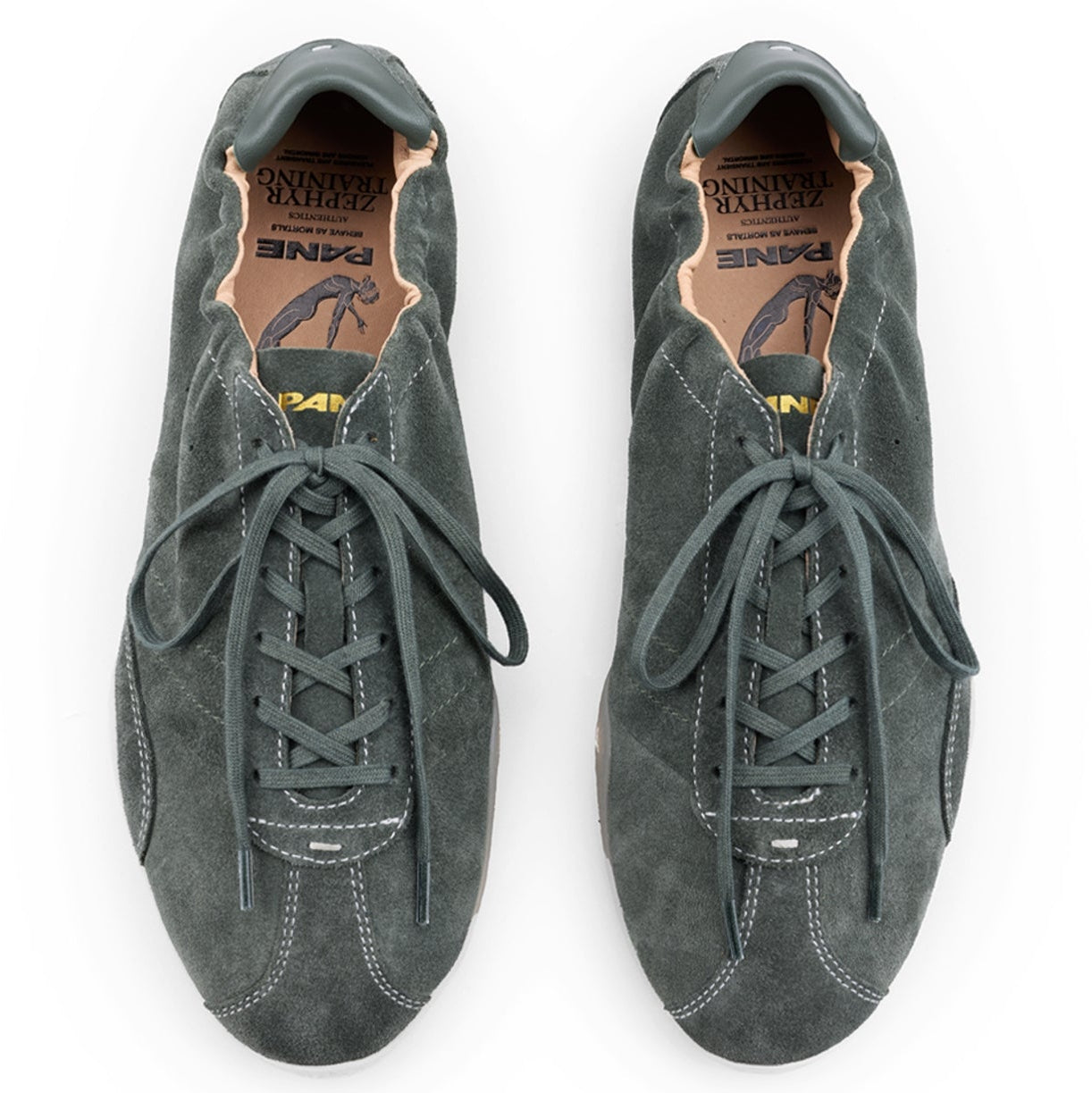 A pair of dark gray suede sneakers with laces, shown from a top-down view on a white background. The shoes have a low-top silhouette with a textured suede finish and a tan interior lining.