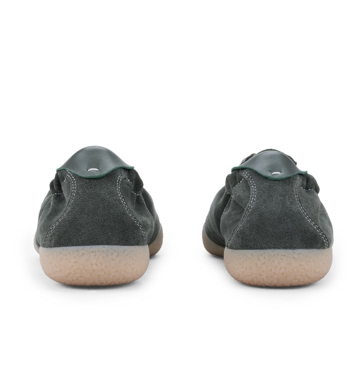 A pair of dark gray suede low-top sneakers shown from the back, featuring light tan rubber soles, displayed on a white background.