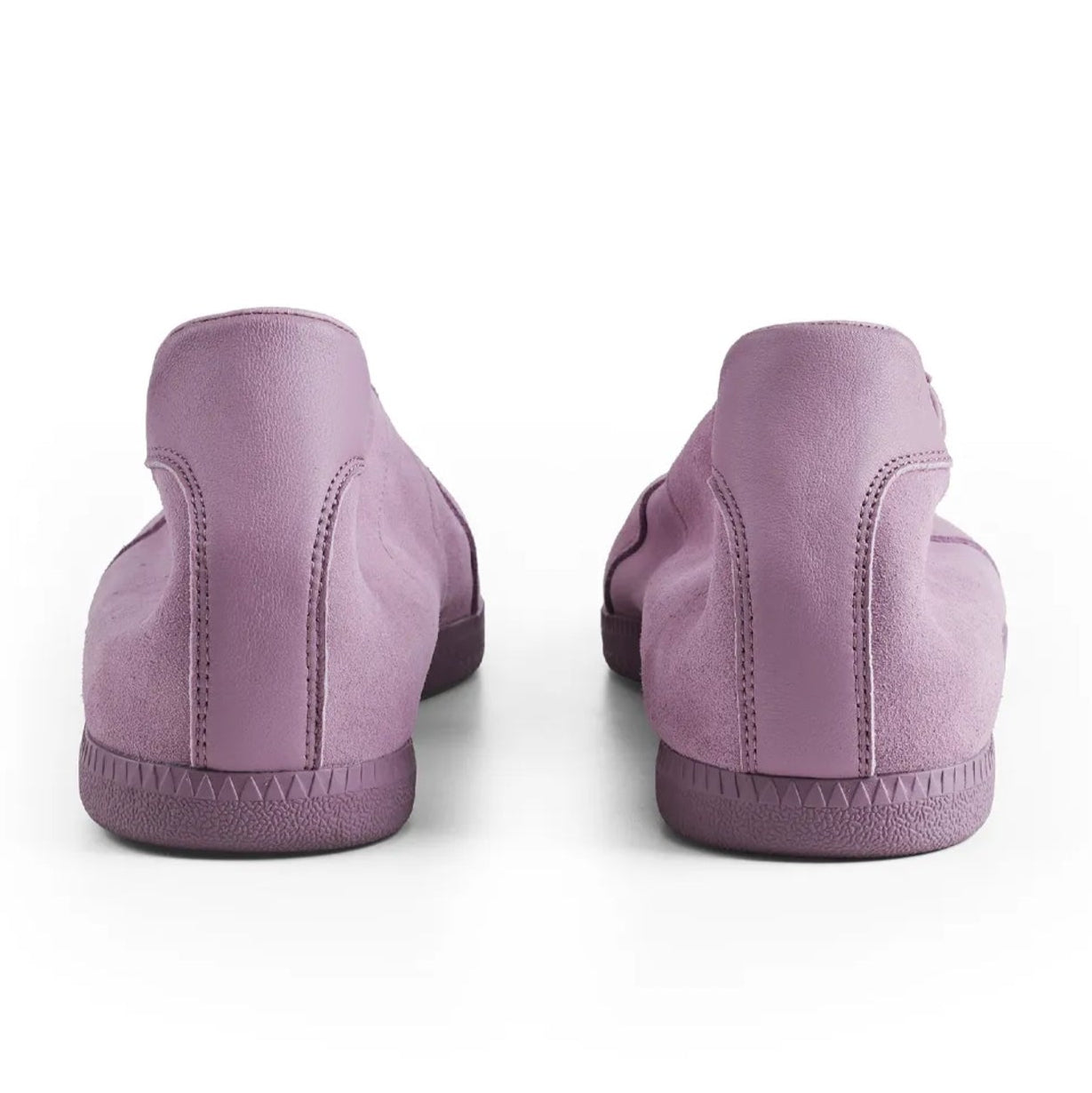 A pair of low-top slip-on shoes shown from the back, in a dusty lavender-purple color, on a plain white background.