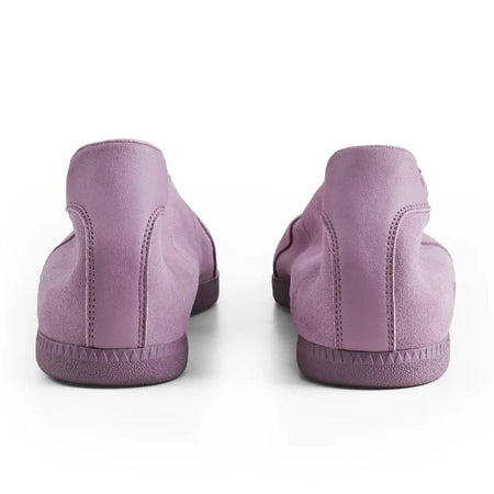 A pair of low-top slip-on shoes shown from the back, in a dusty lavender-purple color, on a plain white background.