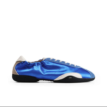 A single low-top athletic shoe in metallic blue with beige side panels and a black sole, shown on a white background within a mobile app interface.