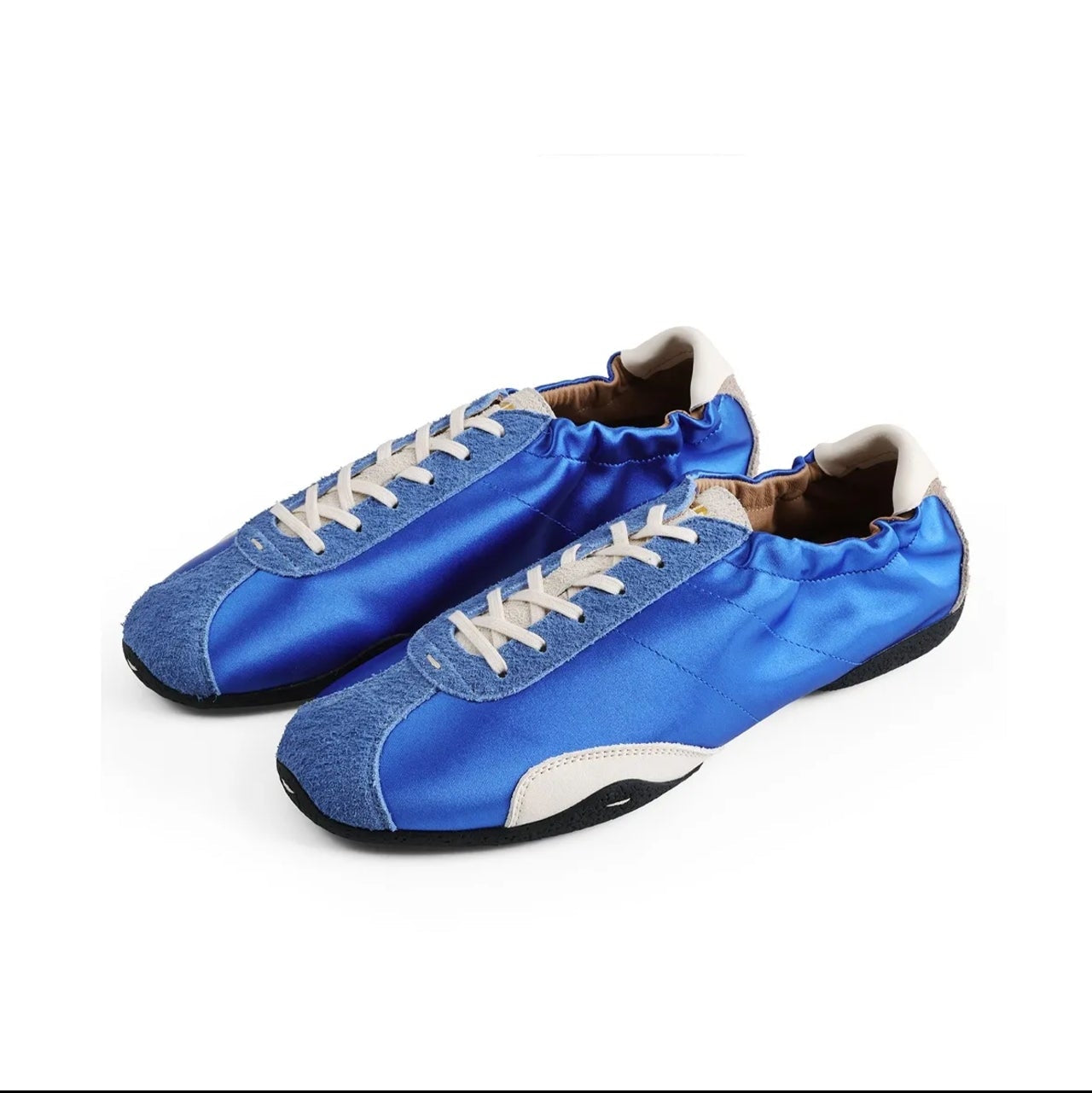 A pair of blue satin and suede low-top sneakers with white laces and white side accents, shown on a white background within a mobile app screenshot.