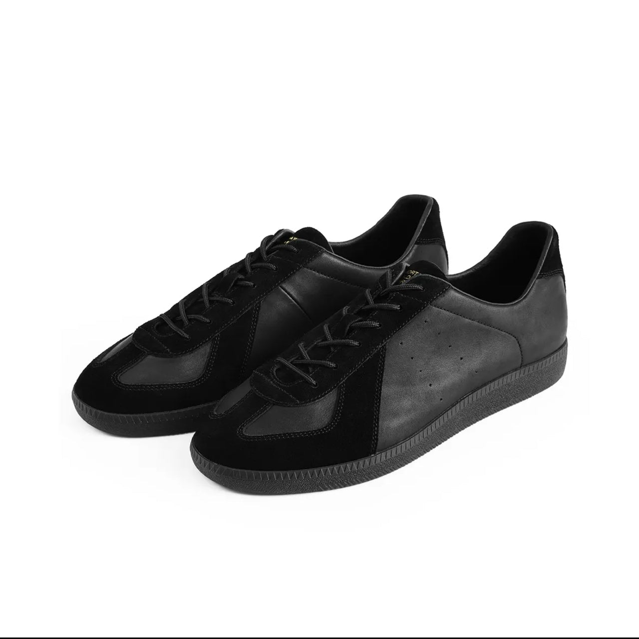 A pair of black low-top sneakers shown on a white background, with black phone app interface bars and text below reading 'BLACK STORK 5265'.