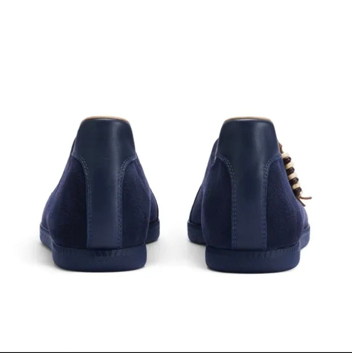 A pair of navy blue suede high-top sneakers shown from the back, displayed on a white background within a mobile app screenshot.