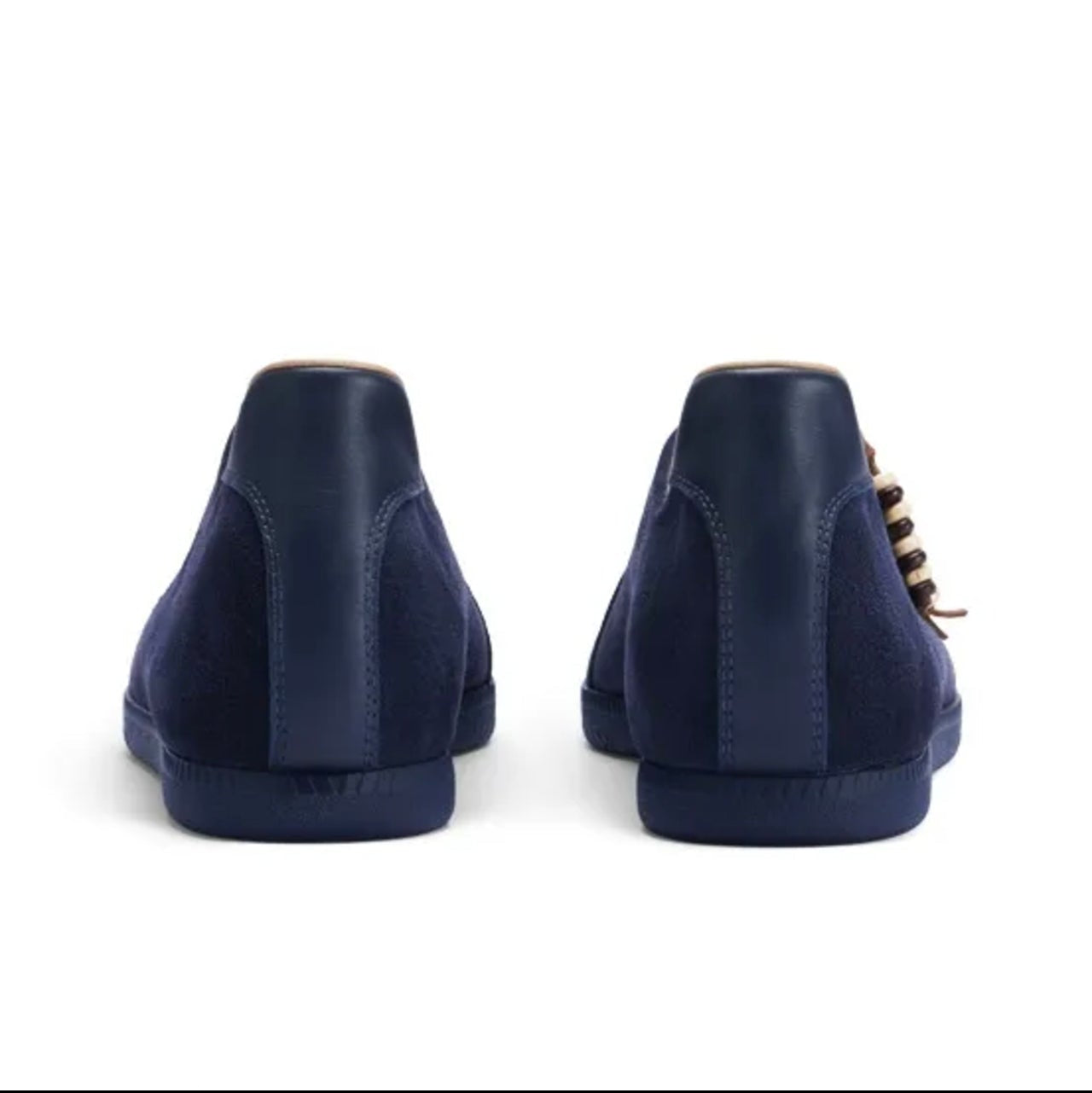 A pair of navy blue suede high-top sneakers shown from the back, displayed on a white background within a mobile app screenshot.
