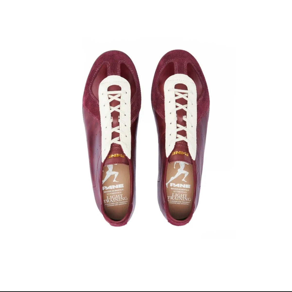 A pair of women's low-top lace-up shoes in a deep crimson red, shown from a top-down view on a white background. The shoes feature white laces and a brown insole with a white logo.