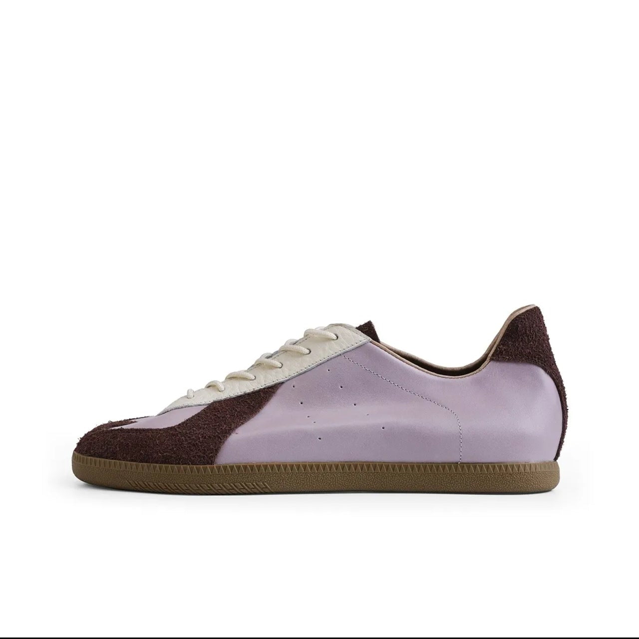 A low-top sneaker shown in side profile on a white background, with a light purple/lavender upper, dark brown heel and toe panels, white laces, and a gum brown sole. The image appears to be a screenshot from a shopping app, with black bars and text labels around the product.