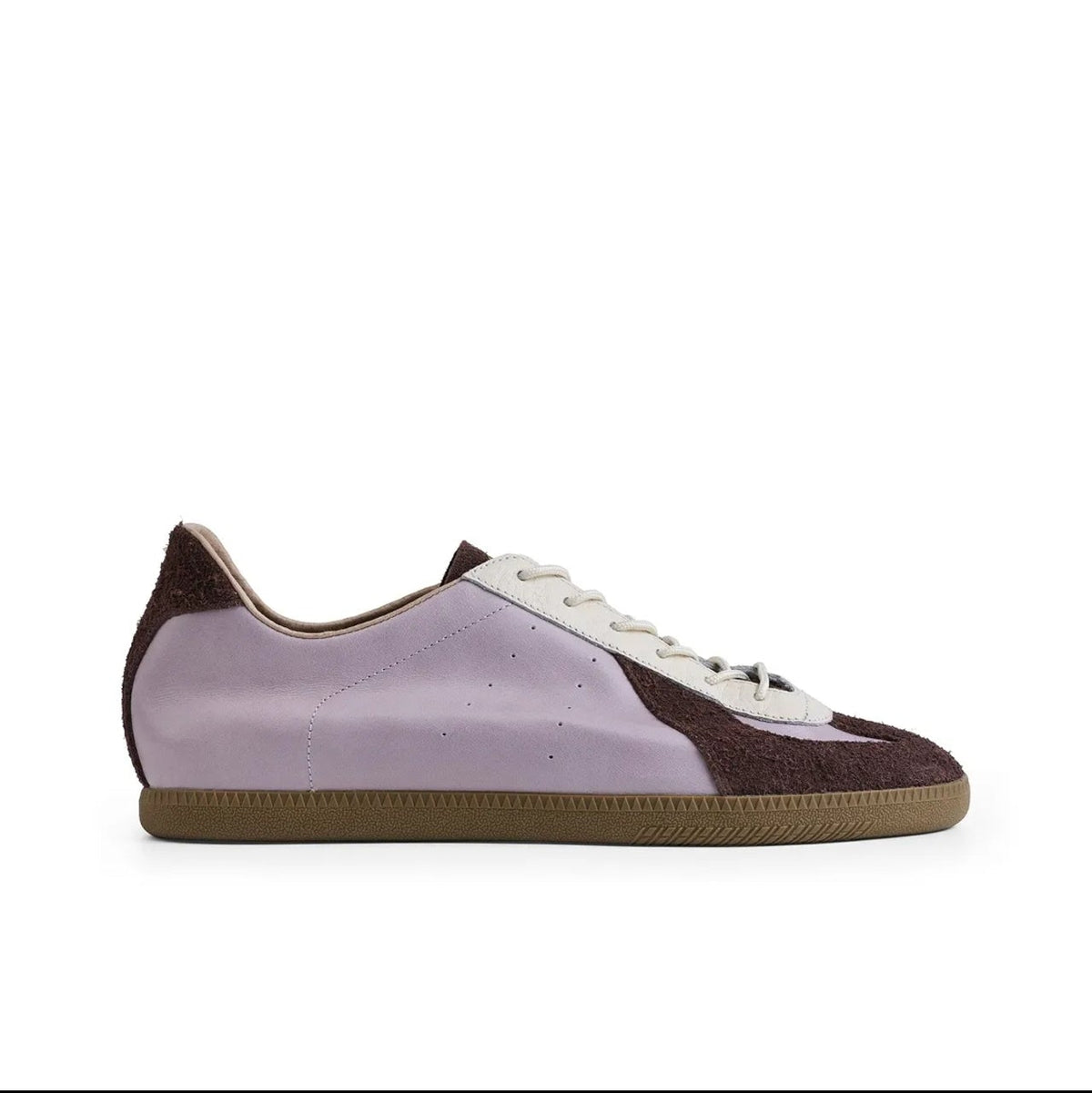 A low-top sneaker shown in side profile on a white background, with a light lavender-purple leather upper, dark brown suede overlays on the heel and toe, white laces, and a brown gum sole. The text 'ARTICOKE 5213' appears below the shoe.