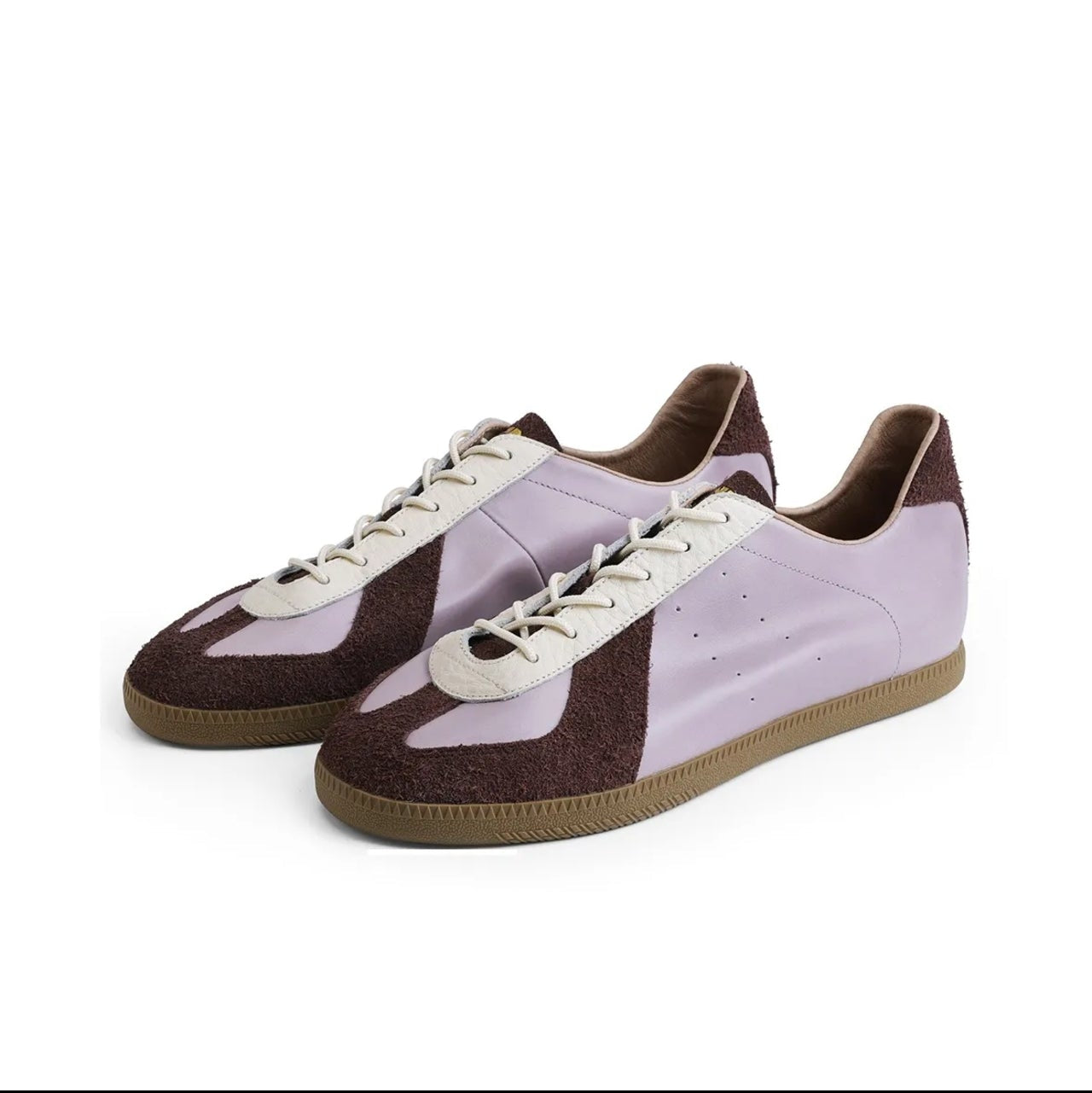 A pair of low-top sneakers shown on a white background within a mobile app screenshot. The shoes have a light lavender-purple upper with dark brown side panels and laces, and a brown gum sole.